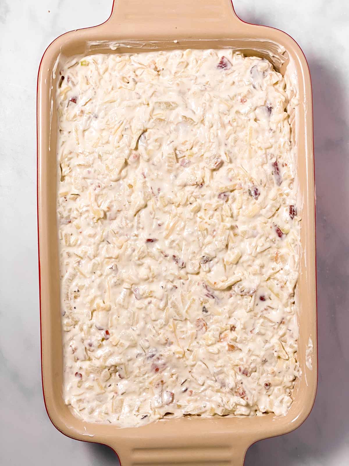 unbaked onion dip in rectangular casserole dish