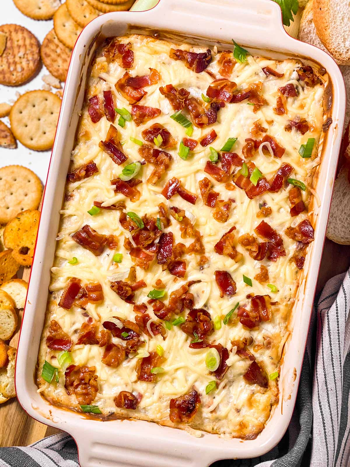 overhead view of hot onion and bacon dip in casserole dish