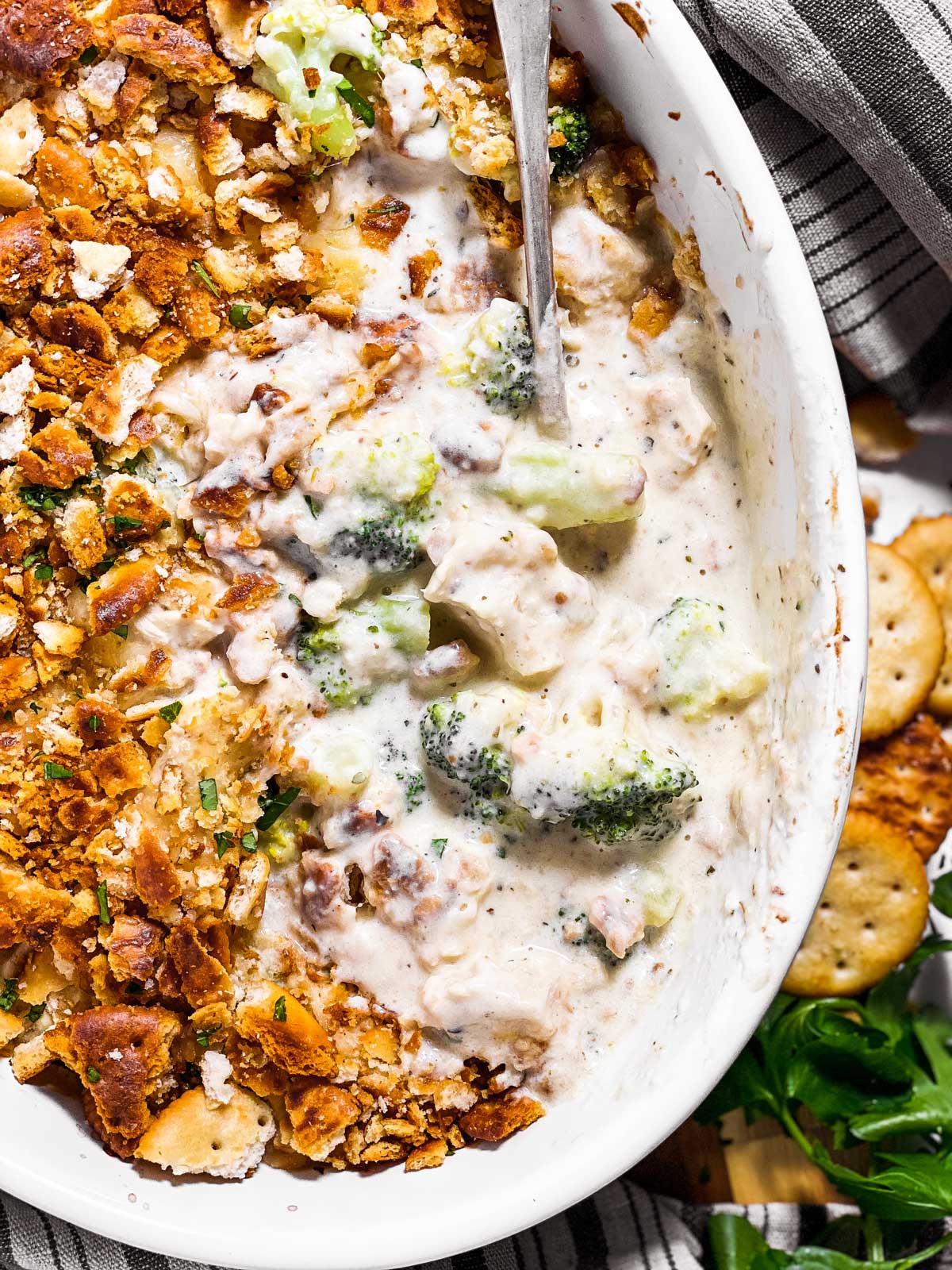 overhead view of spoon in dish with ritz chicken and broccoli casserole
