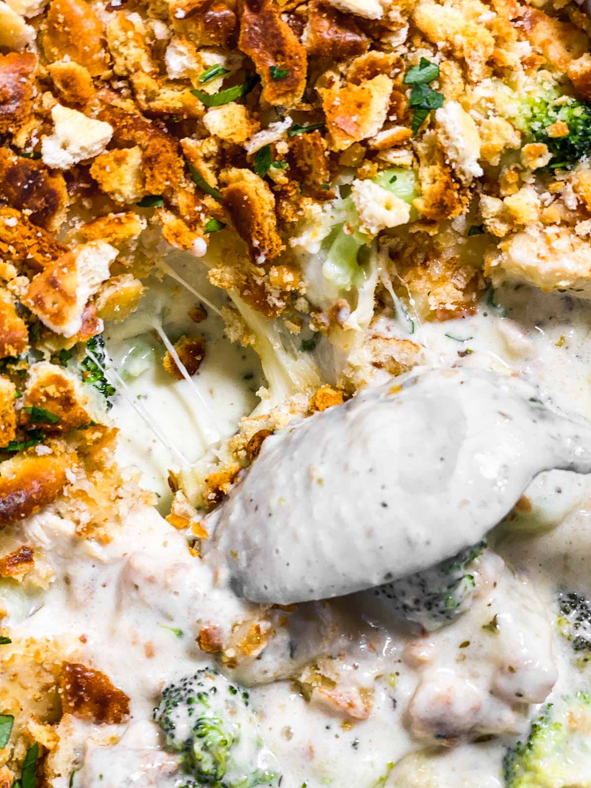 spoon digging through hot chicken broccoli casserole