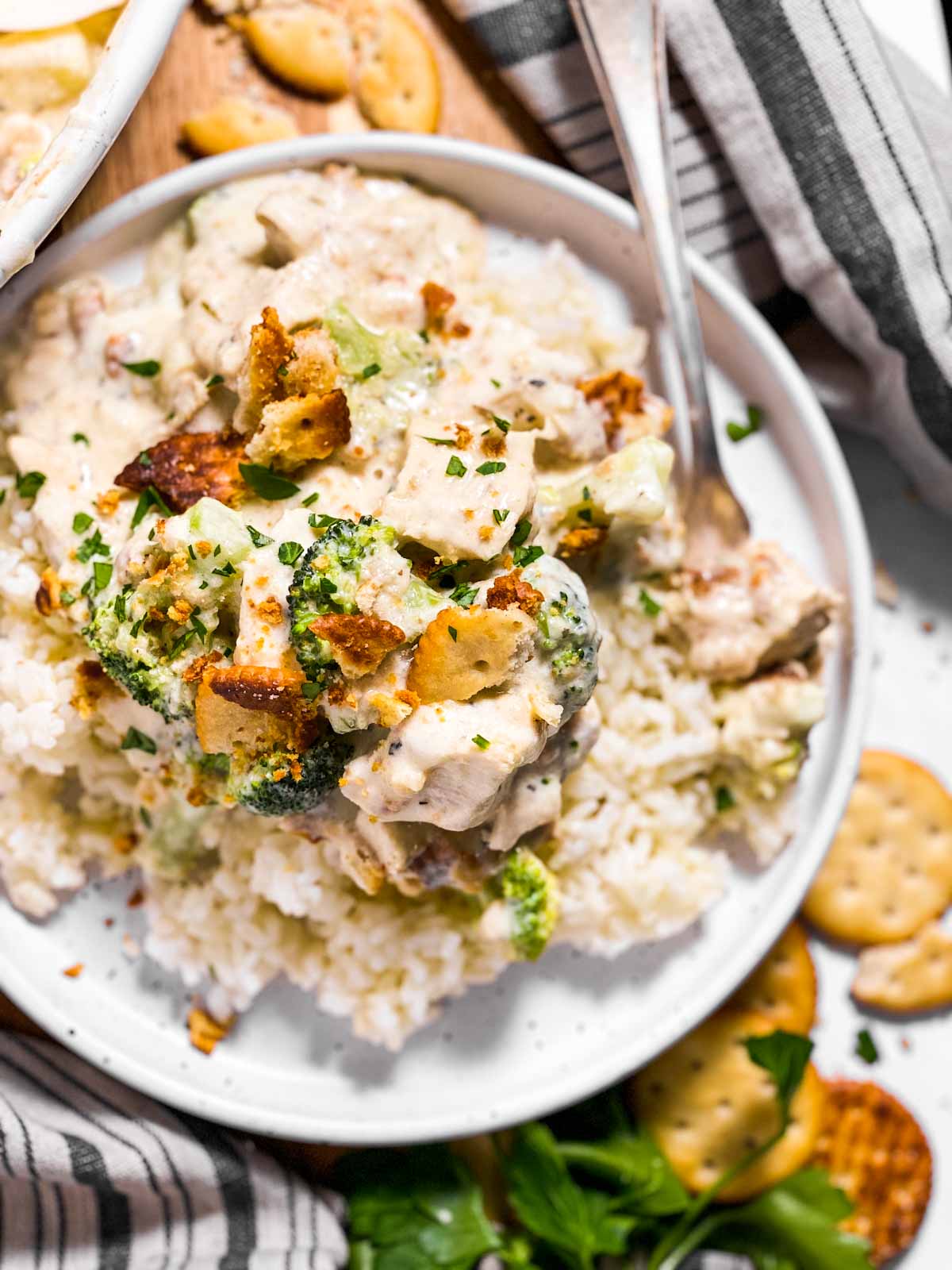 overhead view of ritz chicken broccoli casserole and white rice on white plate