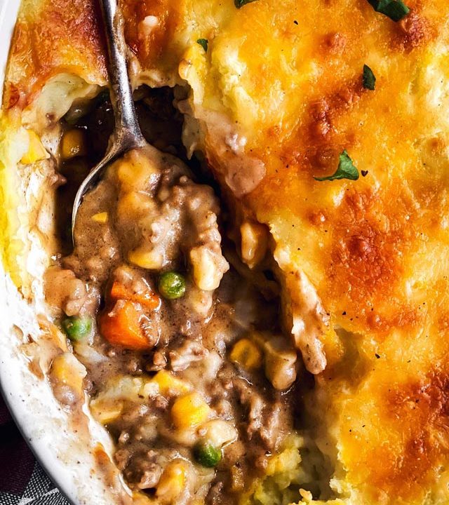 overhead close up view of shepherd's pie in white casserole dish
