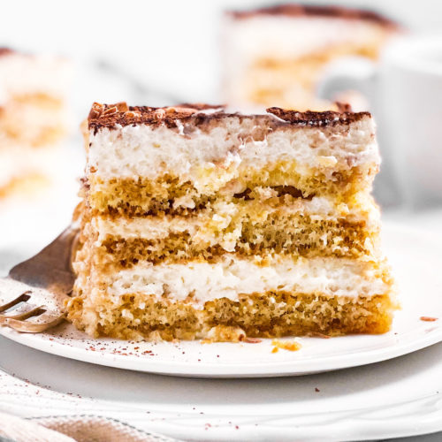 slice of Tiramisu on stack of two white plates