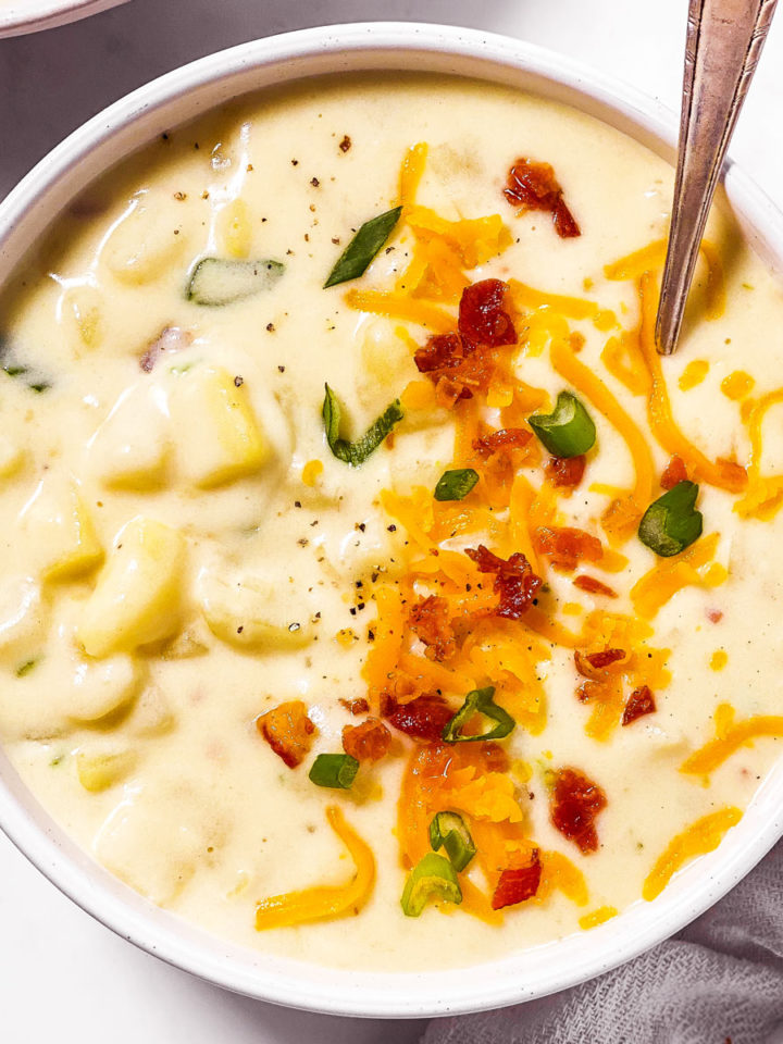 overhead view of white bowl filled with potato soup