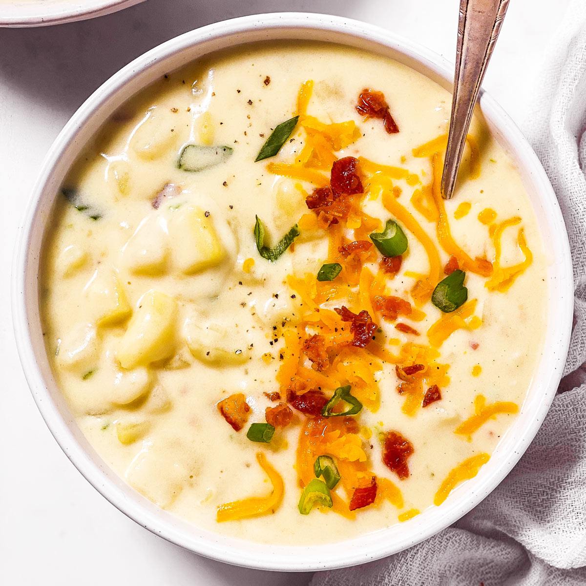 overhead view of white bowl filled with potato soup