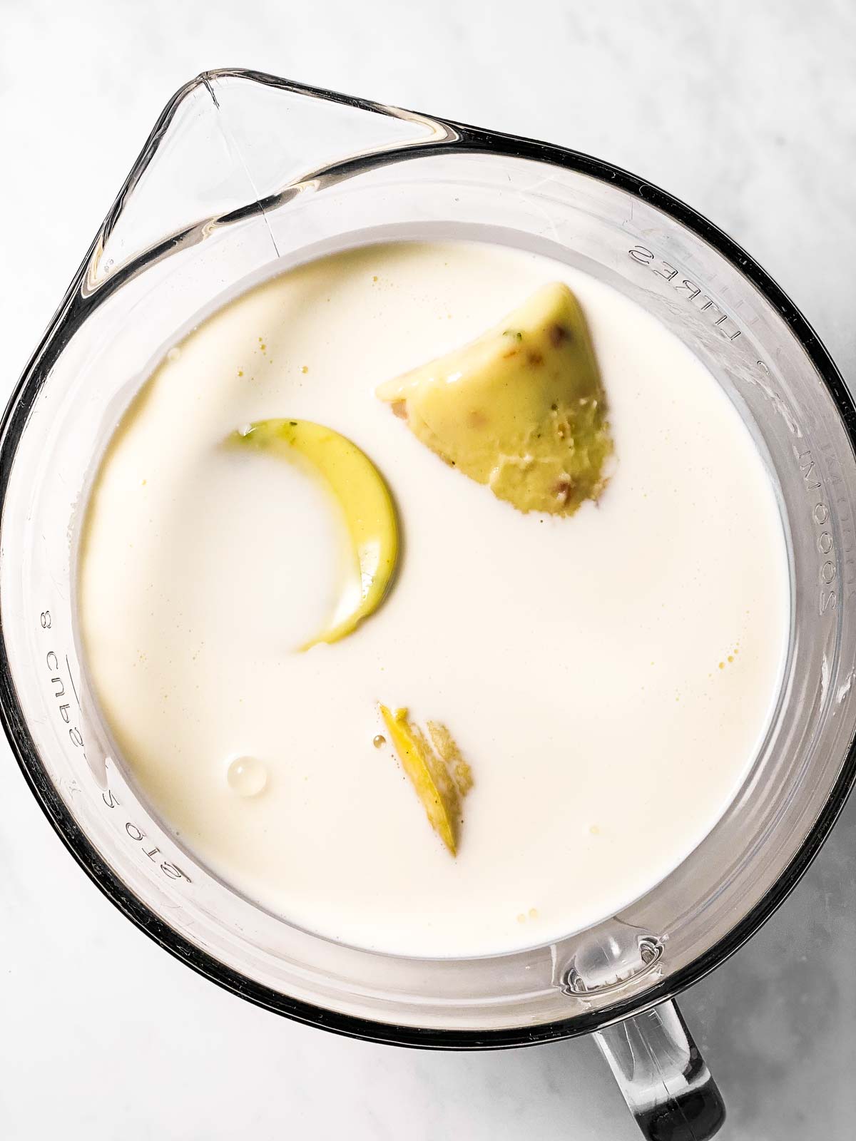 glass bowl with three canned soups and milk