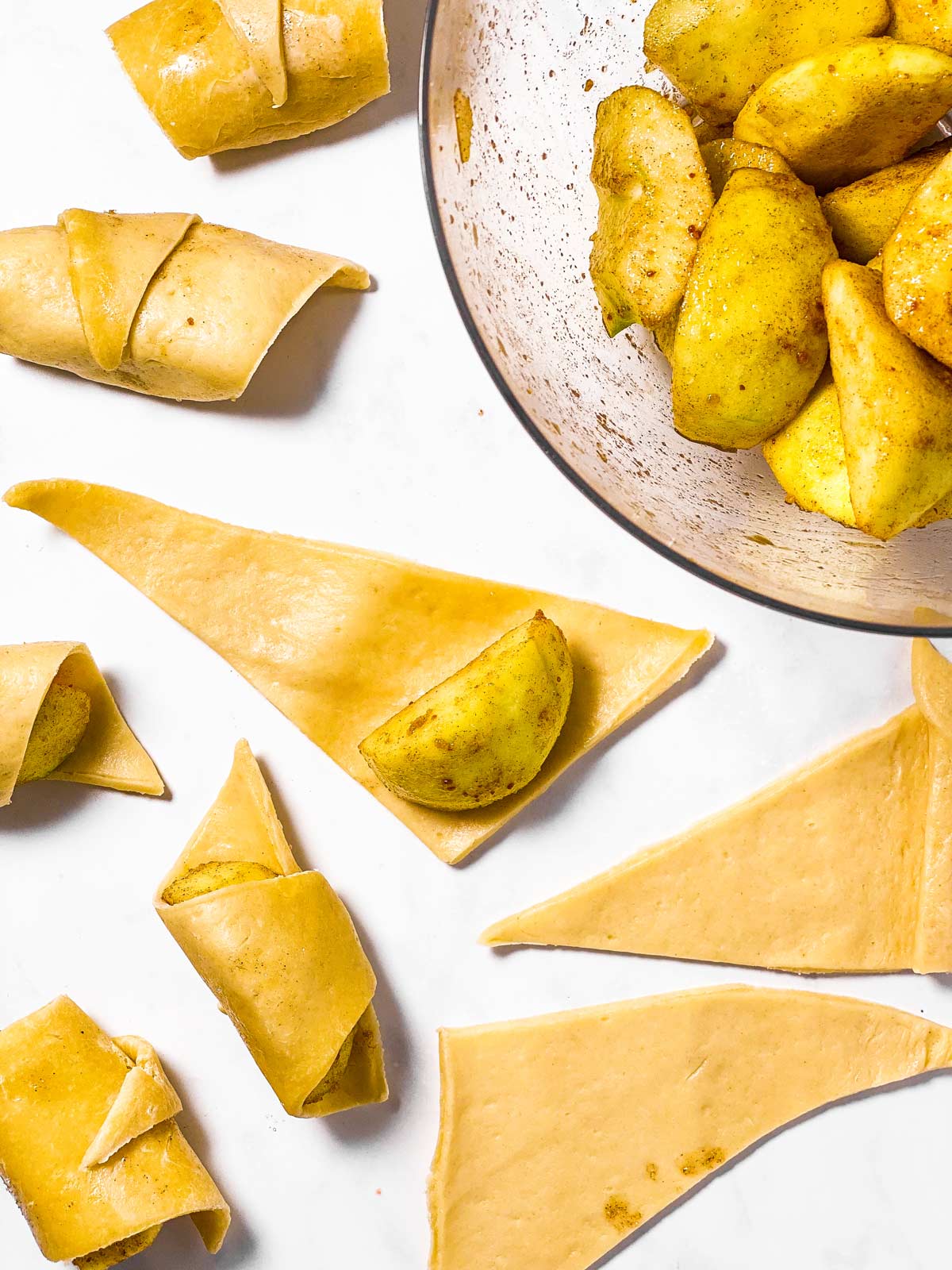 seasoned apple slices on triangles of crescent roll dough