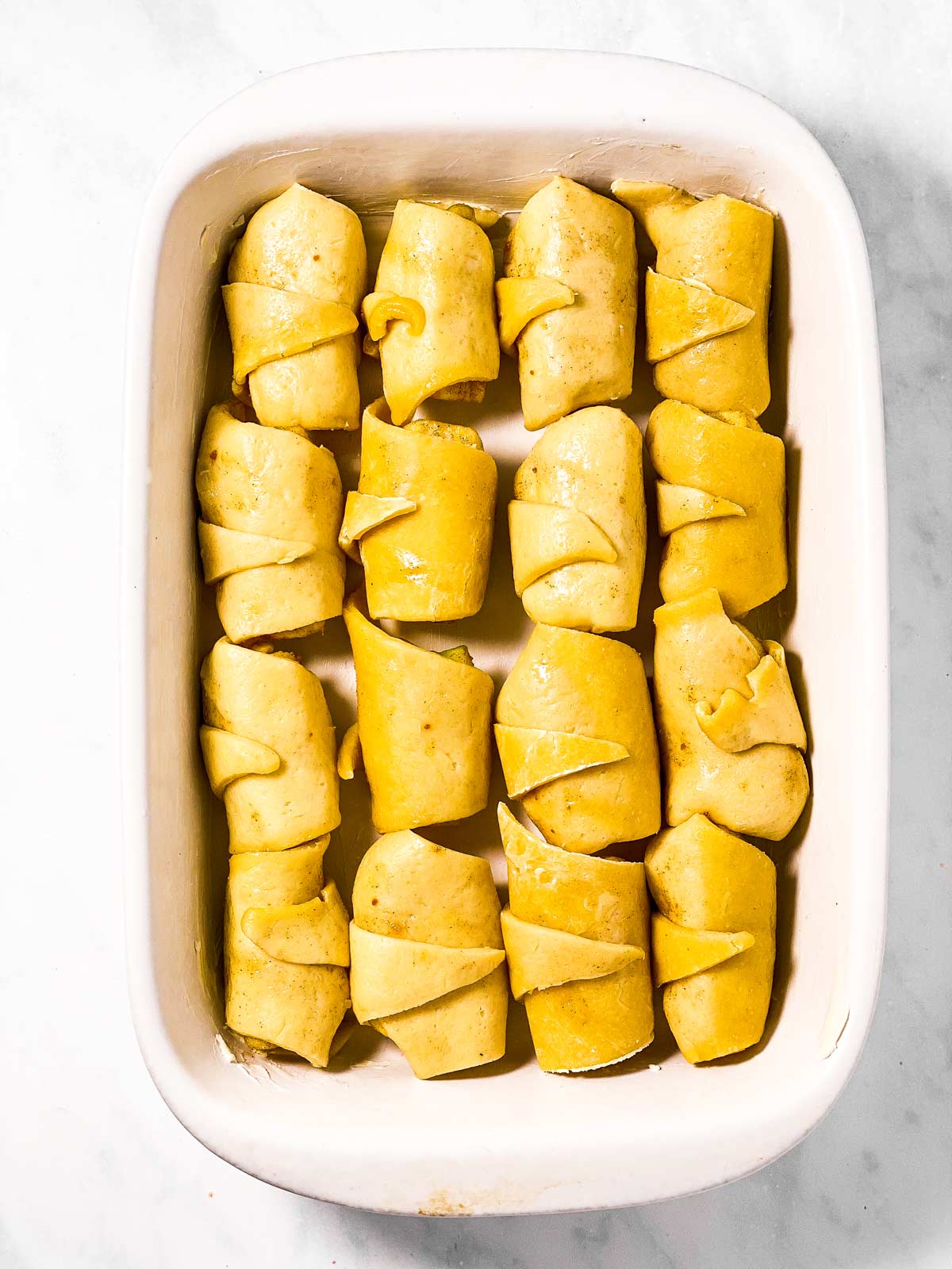 apple dumplings in white rectangular casserole dish