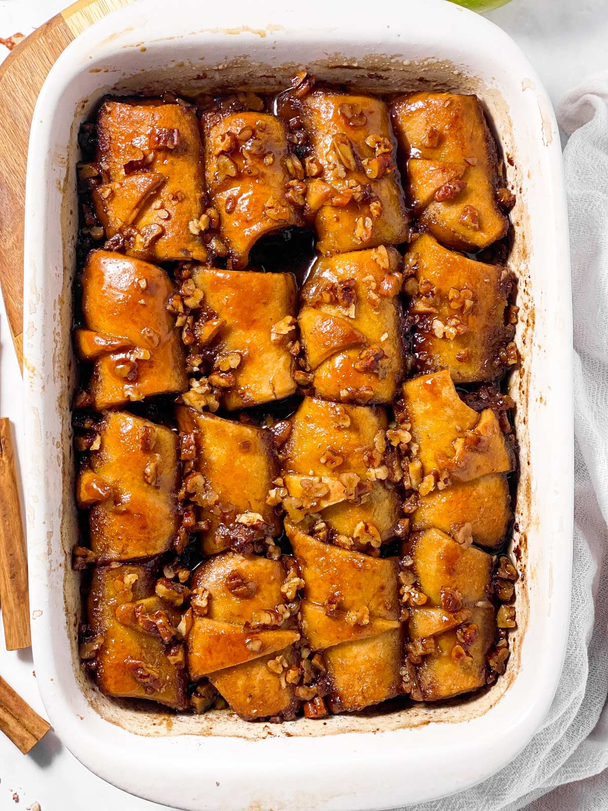 baked apple dumplings in white casserole dish