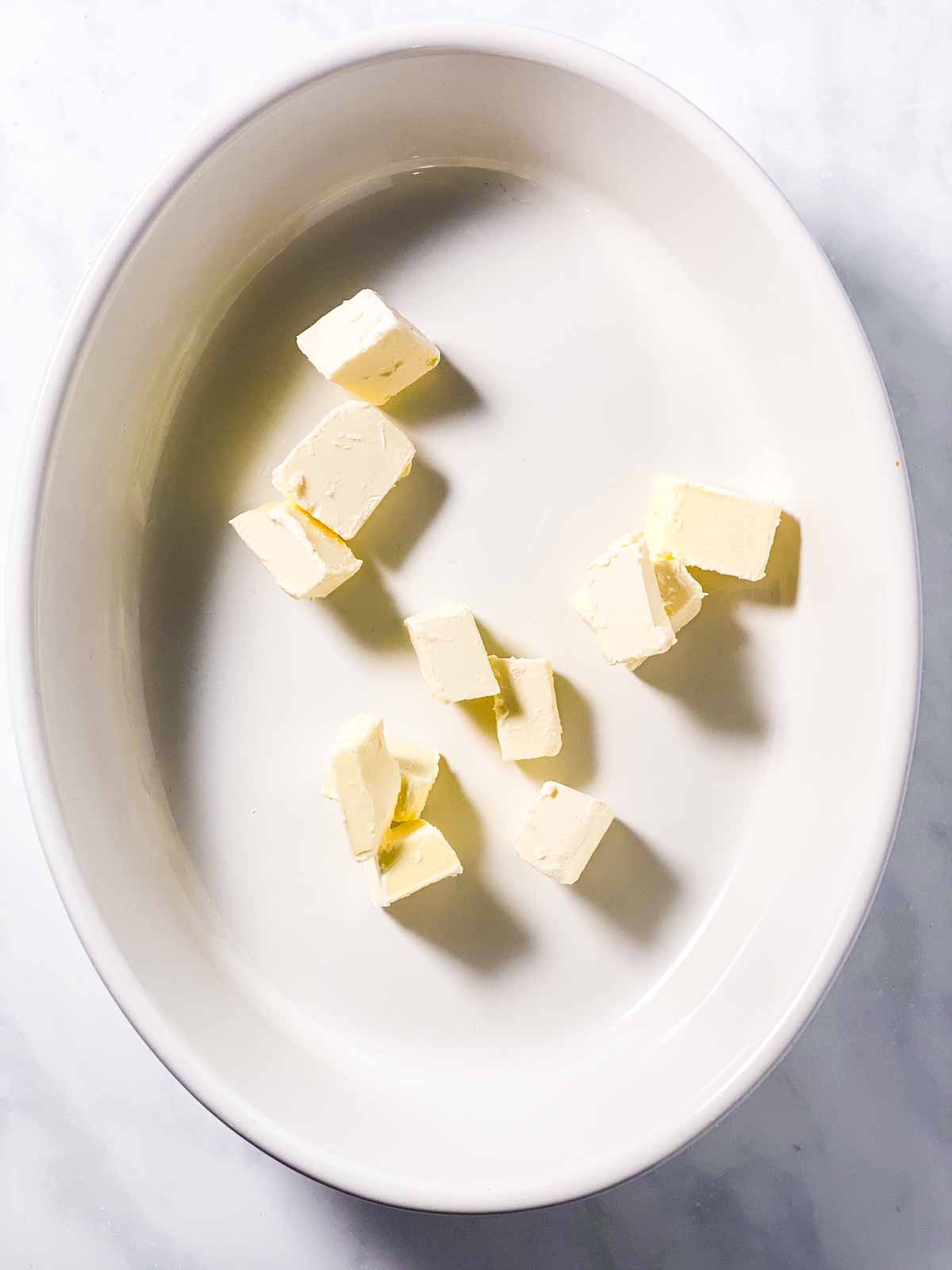 diced margarine in oval white casserole dish