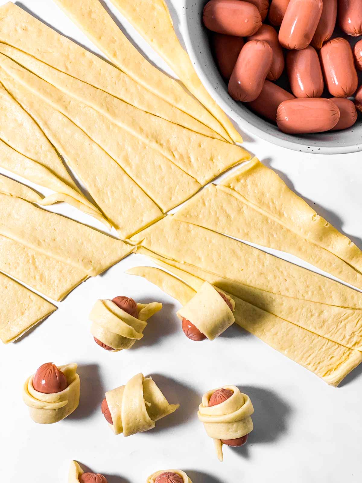 seven little smokies wrapped in strips of crescent roll dough