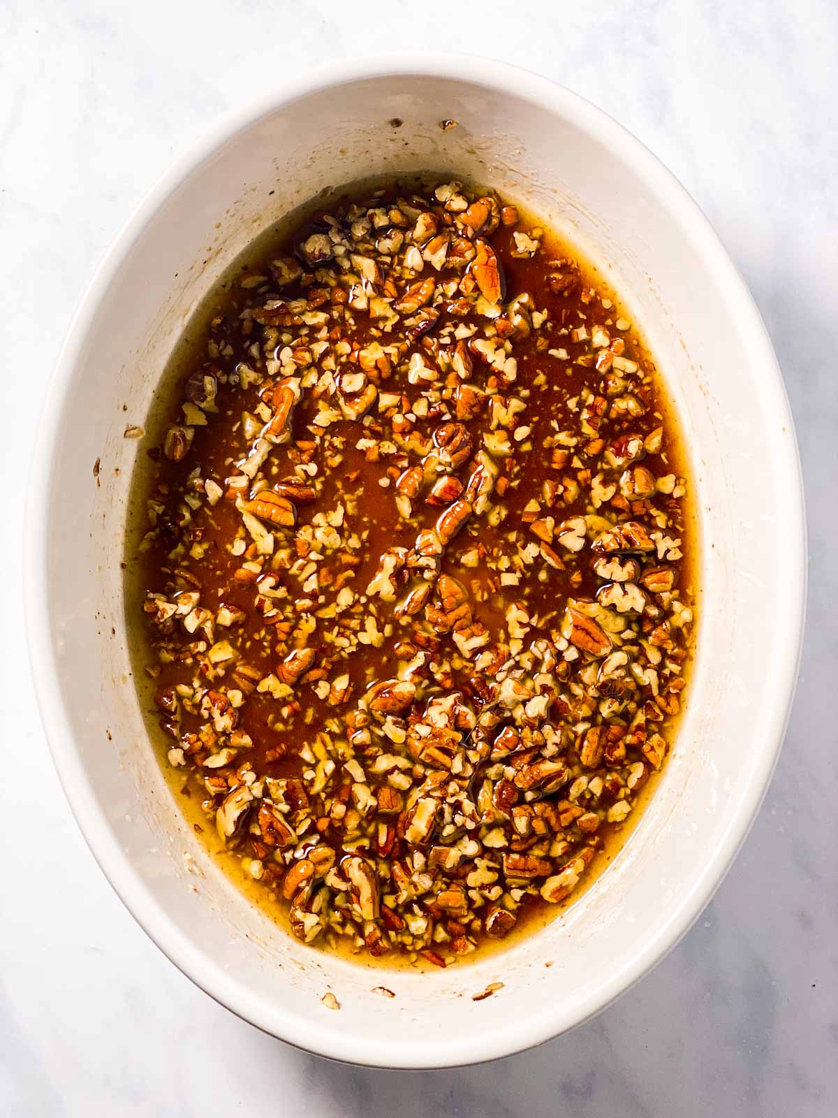 pecan brown sugar sauce in white oval casserole dish