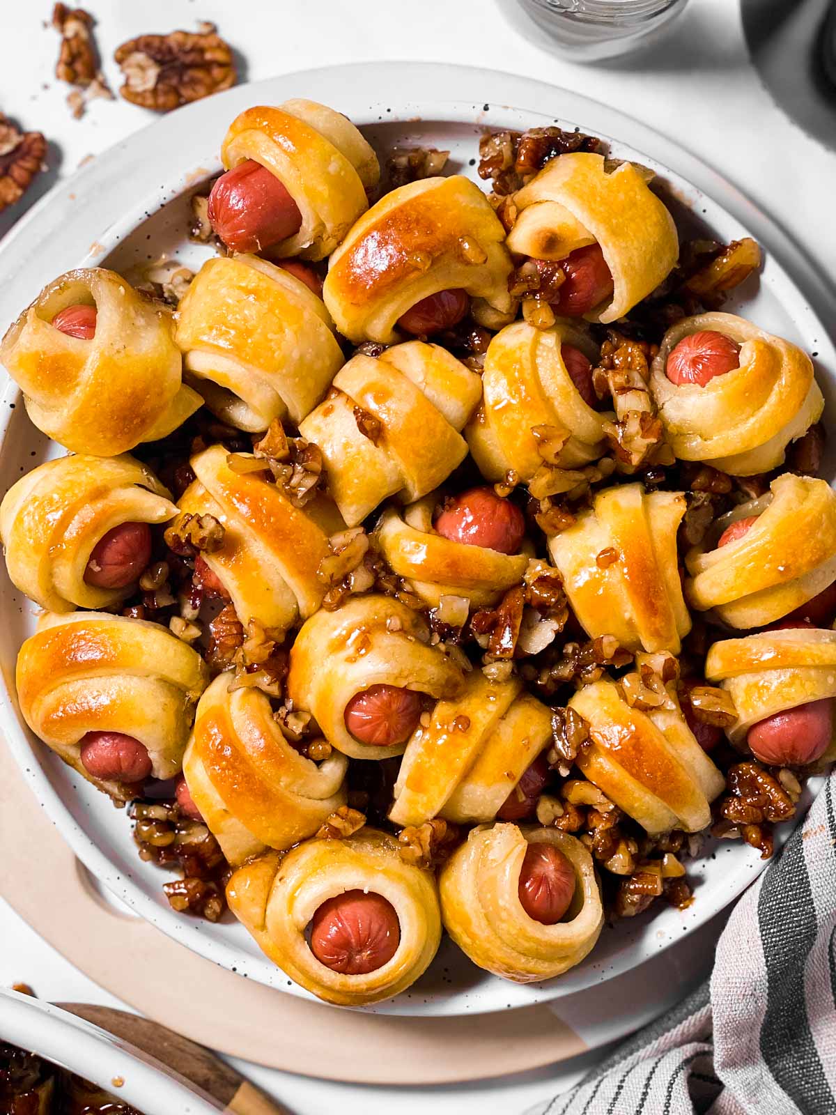 overhead view of plate filled with little smokies in crescent rolls with sticky pecans