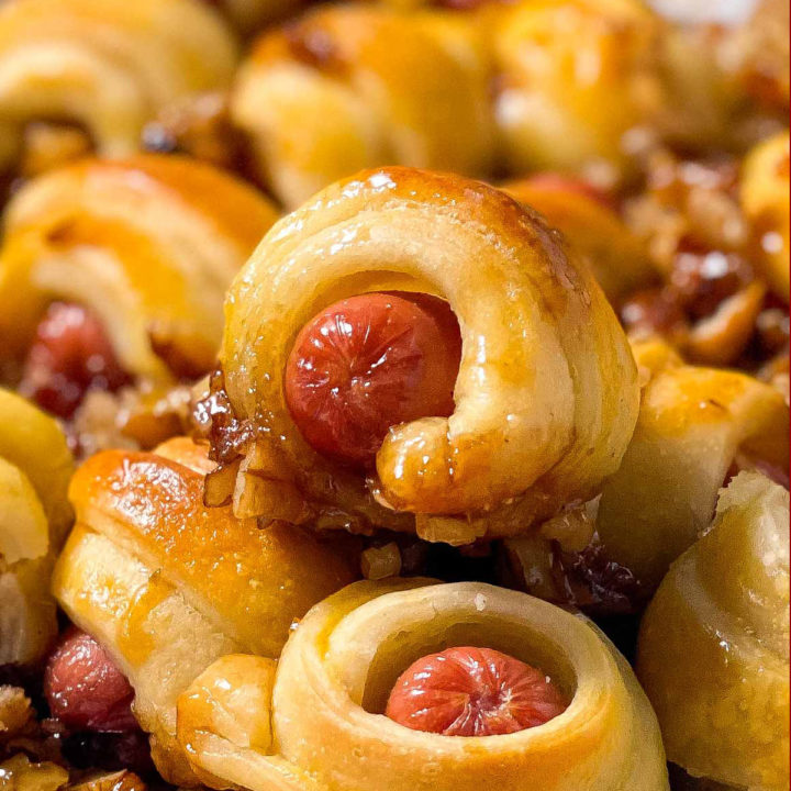 frontal close up photo of caramelized lil smokies crescent rolls