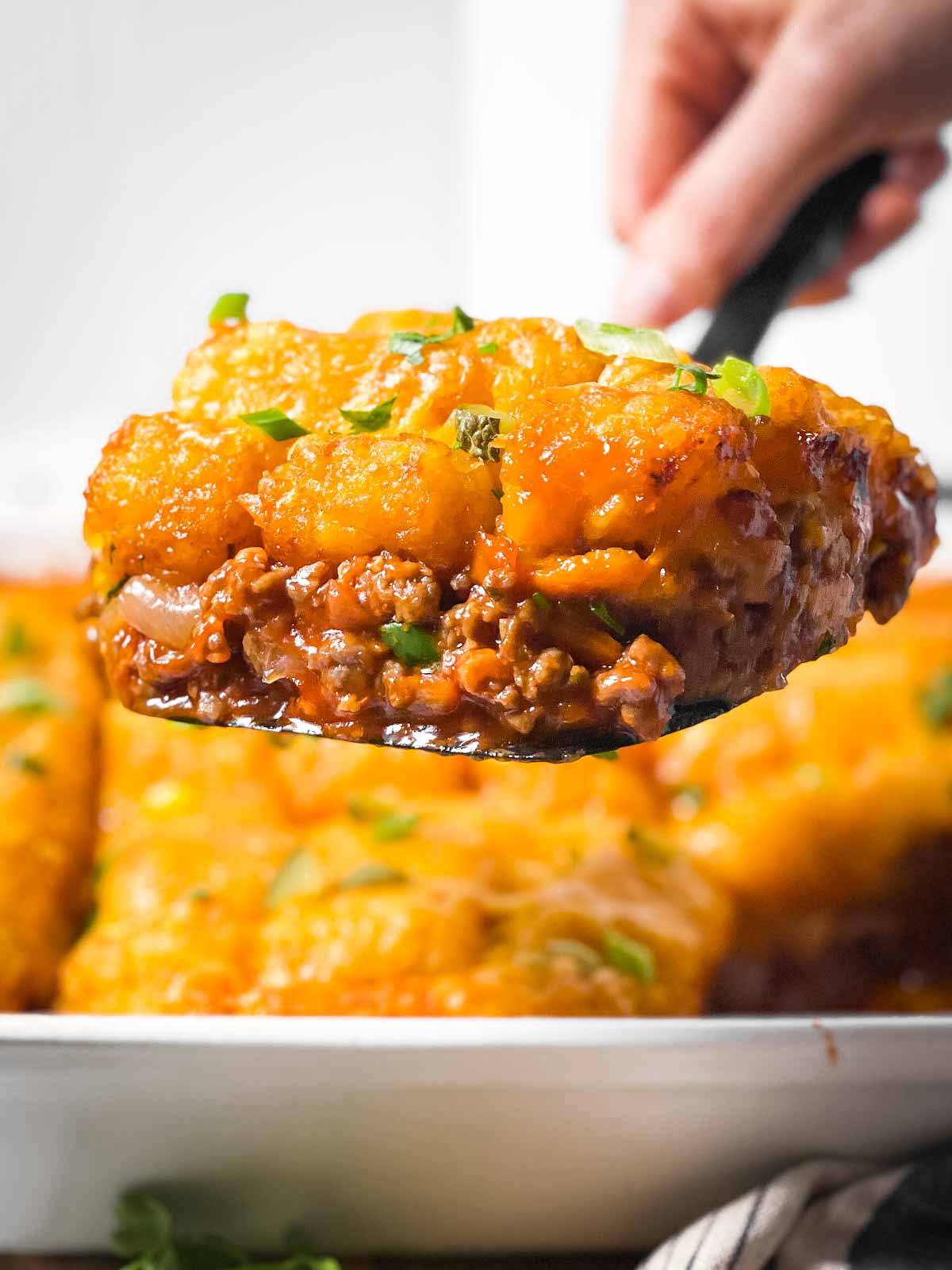 slice of sloppy joe casserole on serving spoon